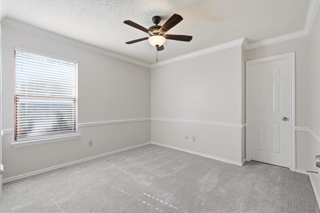 318 Lodge Road Coppell, TX 75019 - Photo 26 of 35 This comfortable secondary bedroom features fresh neutral tones, plush carpeting, crown molding and natural light.
