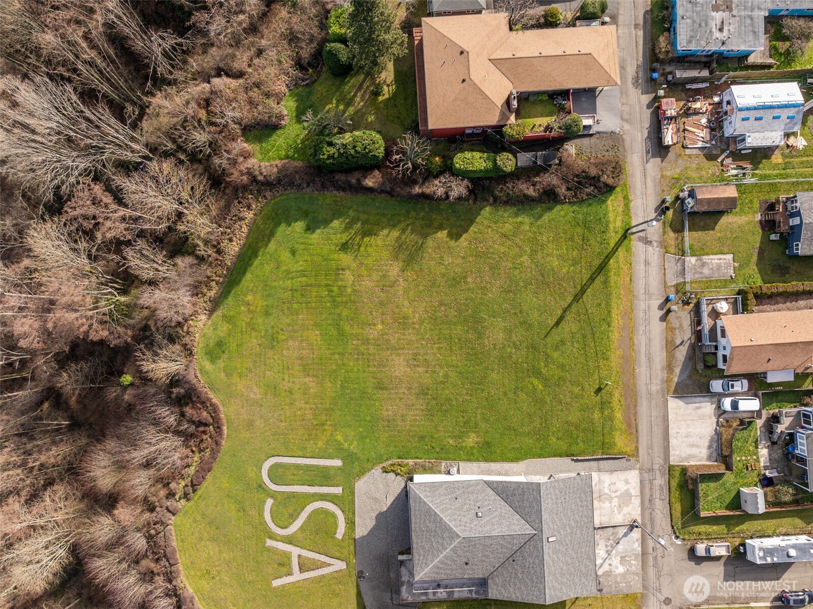 an aerial view of residential houses with outdoor space