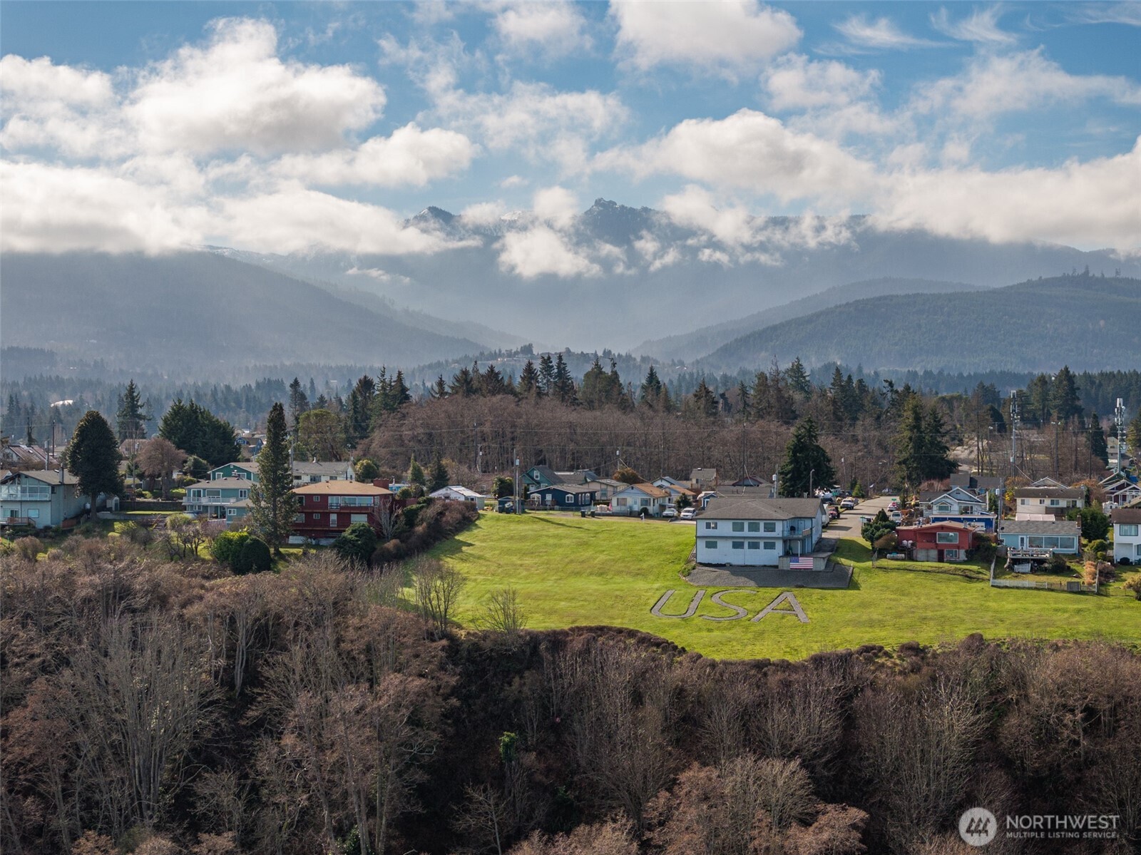 999 West 4th Street Port Angeles, WA 98363 - Photo 3 of 22 a view of a swimming pool with lawn chairs and a fire pit