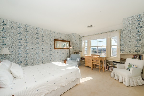 208 Argilla Road Ipswich, MA 01938 - Photo 24 of 30 a spacious bedroom with a bed and a couch