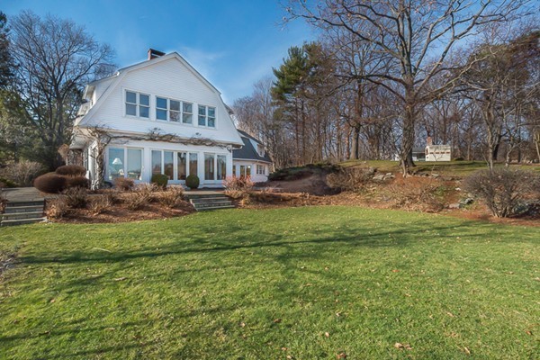 208 Argilla Road Ipswich, MA 01938 - Photo 25 of 30 a front view of a house with a yard table and chairs