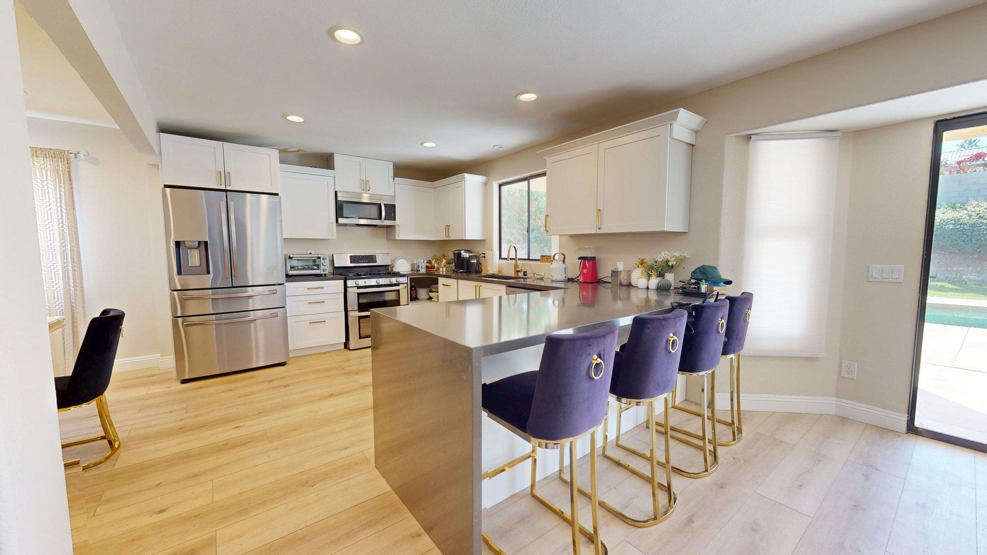68645 Panorama Road Cathedral City, CA 92234 - Photo 10 of 35 a kitchen with kitchen island granite countertop wooden floors and stainless steel appliances