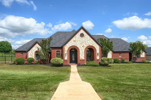 a front view of house with yard and green space