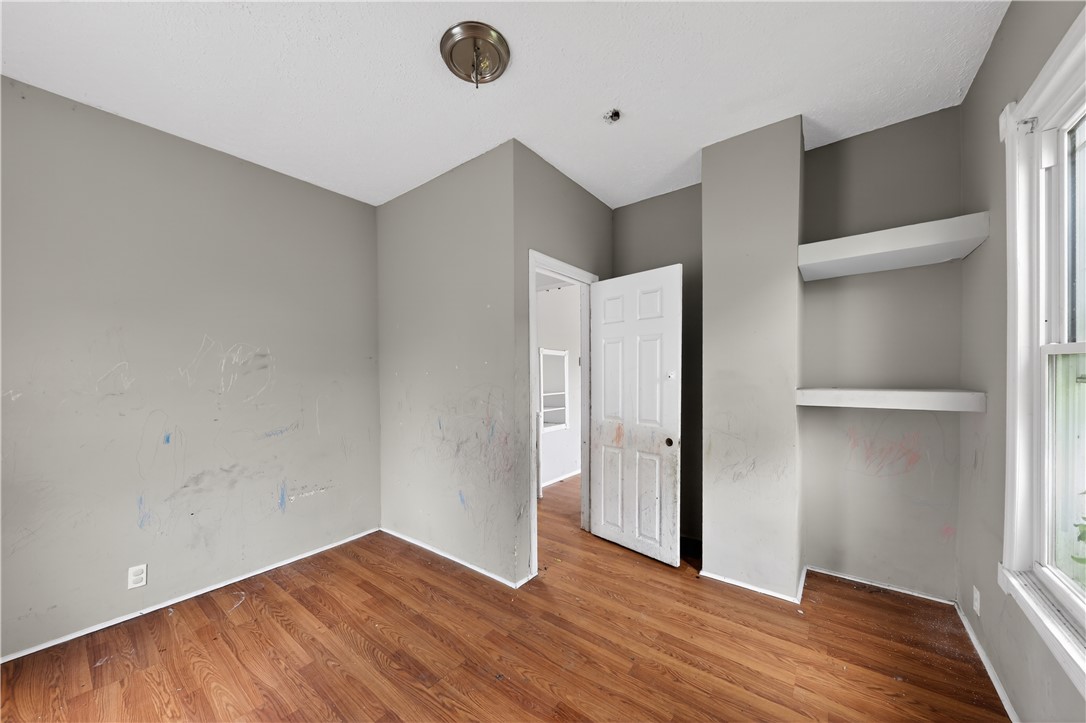205 Rita Street Dayton, OH 45404 - Photo 15 of 34 This spacious room features ample natural light, durable flooring, and built-in shelving.