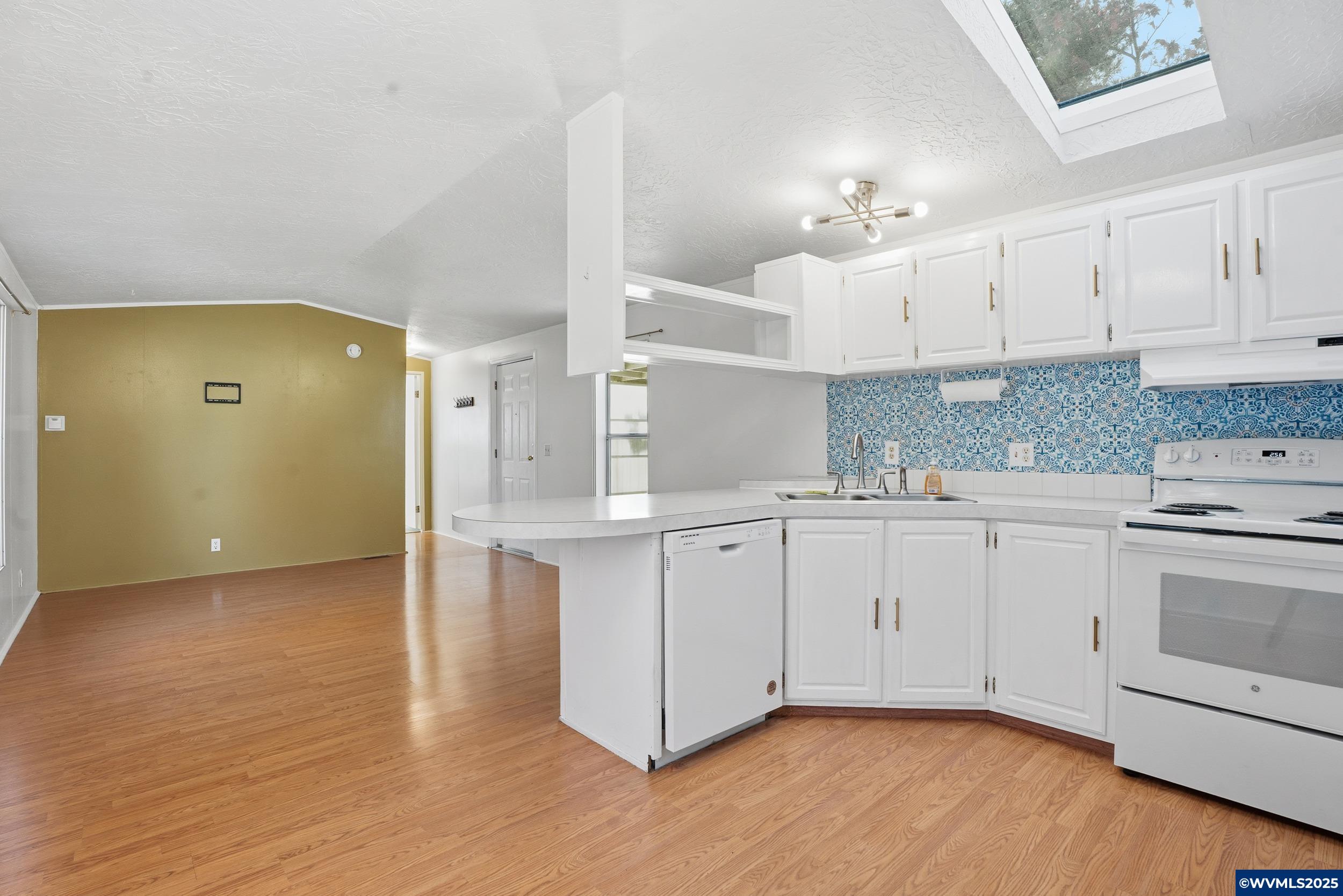 277 Edwards Road, Unit 145 Monmouth, OR 97361 - Photo 10 of 47 a kitchen with cabinets wooden floor and a sink