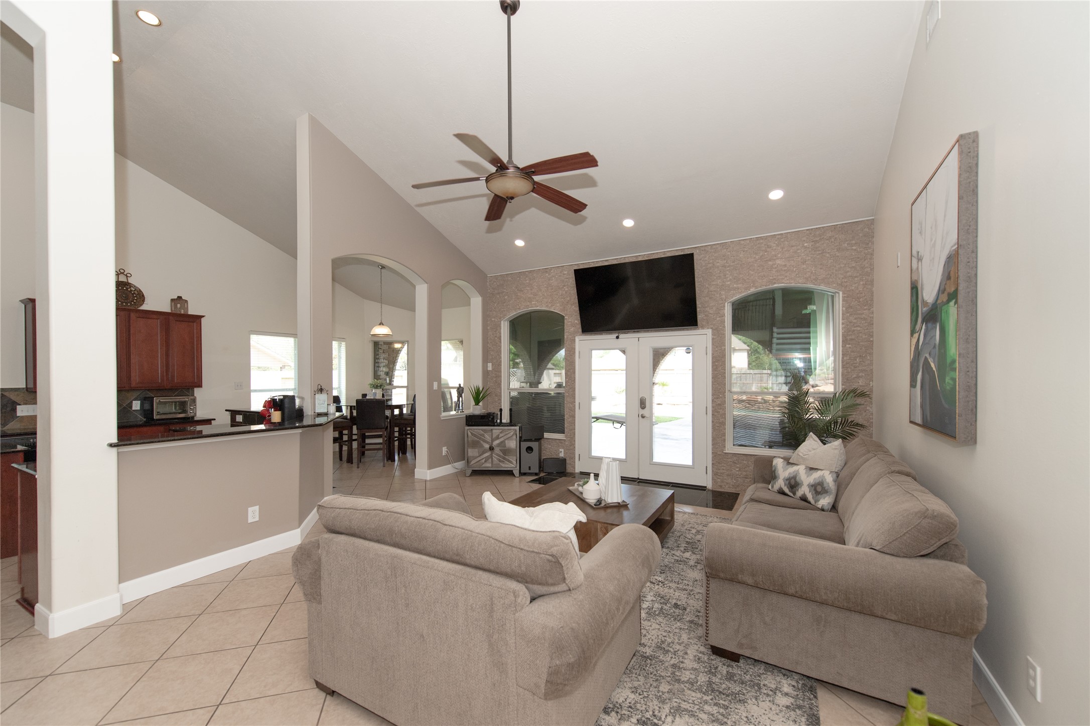 1914 Lakeside Crossing Katy, TX 77494 - Photo 13 of 44 a living room with furniture kitchen view and a wooden floor