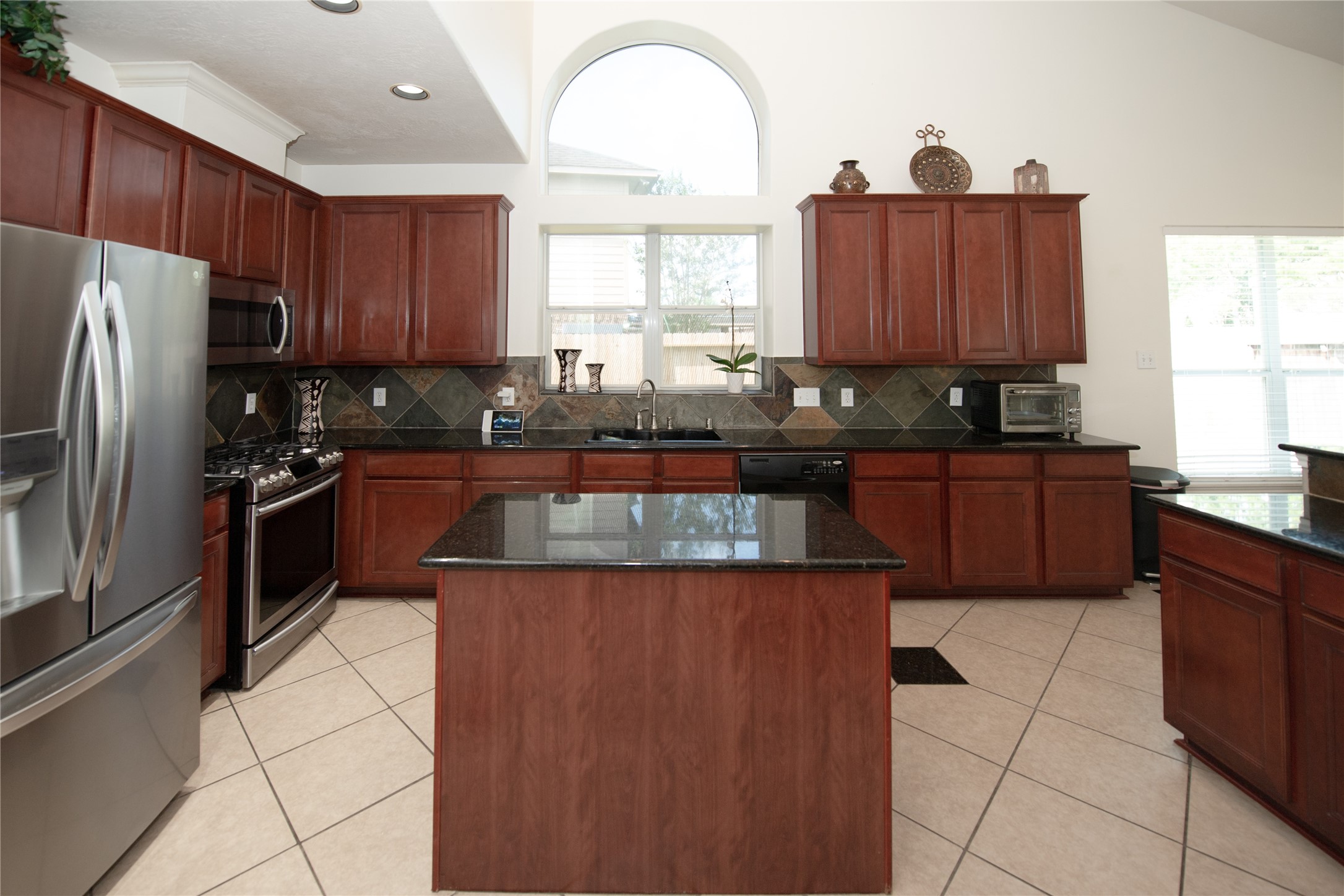 1914 Lakeside Crossing Katy, TX 77494 - Photo 15 of 44 a kitchen with stainless steel appliances granite countertop a stove a sink dishwasher and a refrigerator