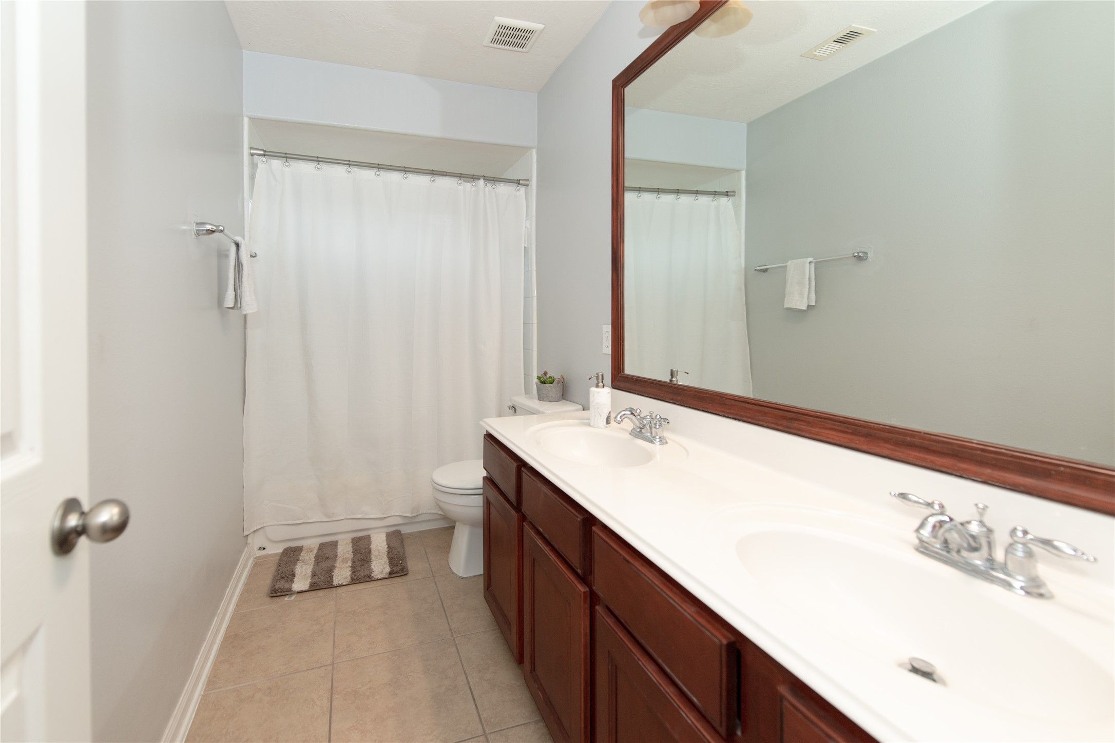 1914 Lakeside Crossing Katy, TX 77494 - Photo 26 of 44 a bathroom with a sink and a mirror
