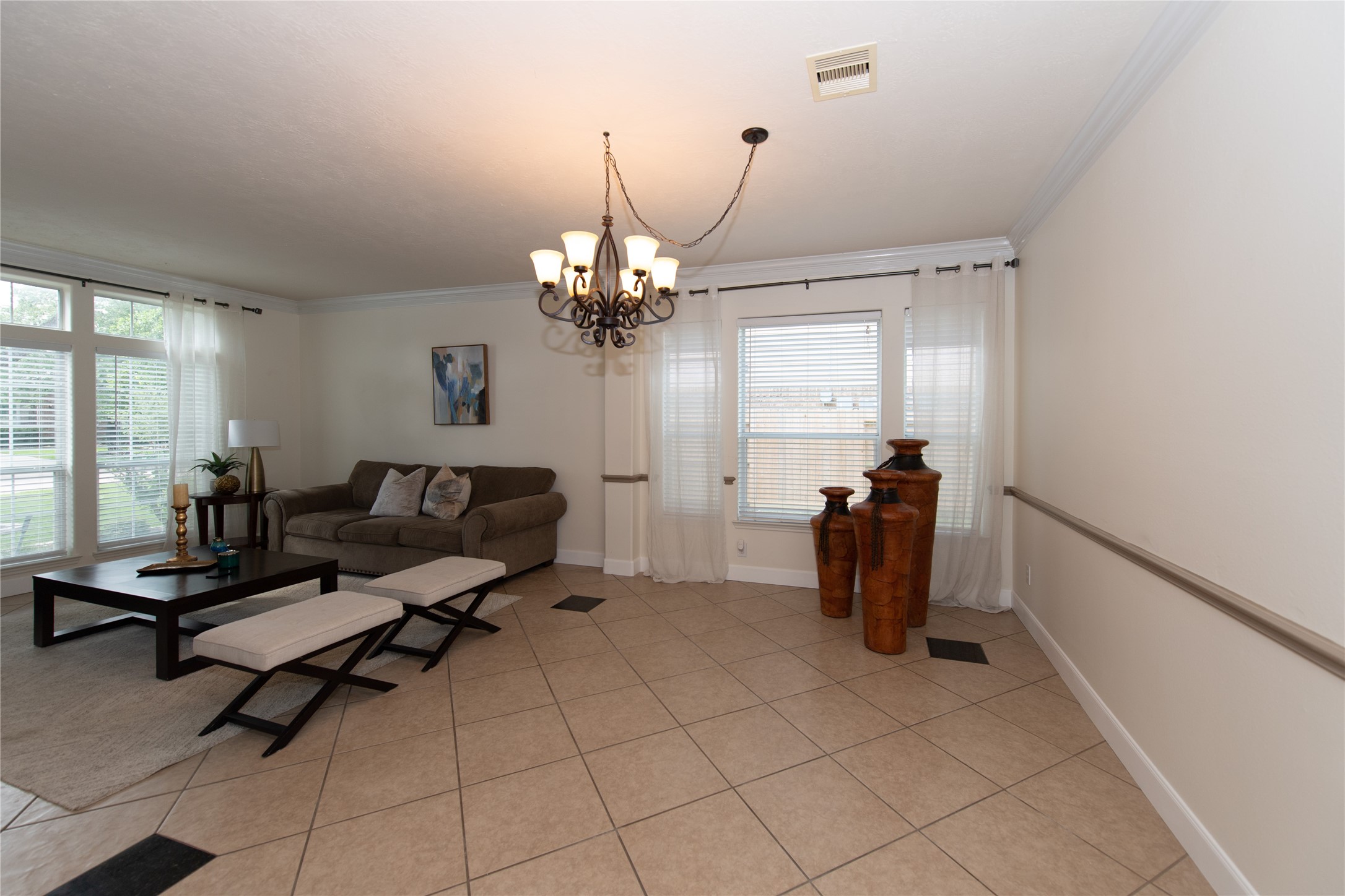 1914 Lakeside Crossing Katy, TX 77494 - Photo 5 of 44 a living room with furniture and a chandelier