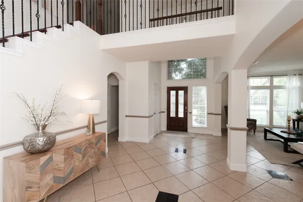 a living room with furniture and a chandelier