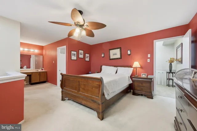 a bedroom with a bed and ceiling fan