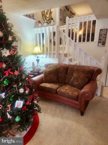 a living room with furniture and flowers