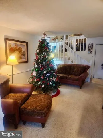 a living room with furniture and flowers