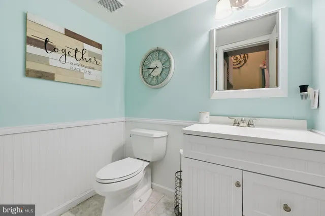 a bathroom with a toilet a sink and a mirror