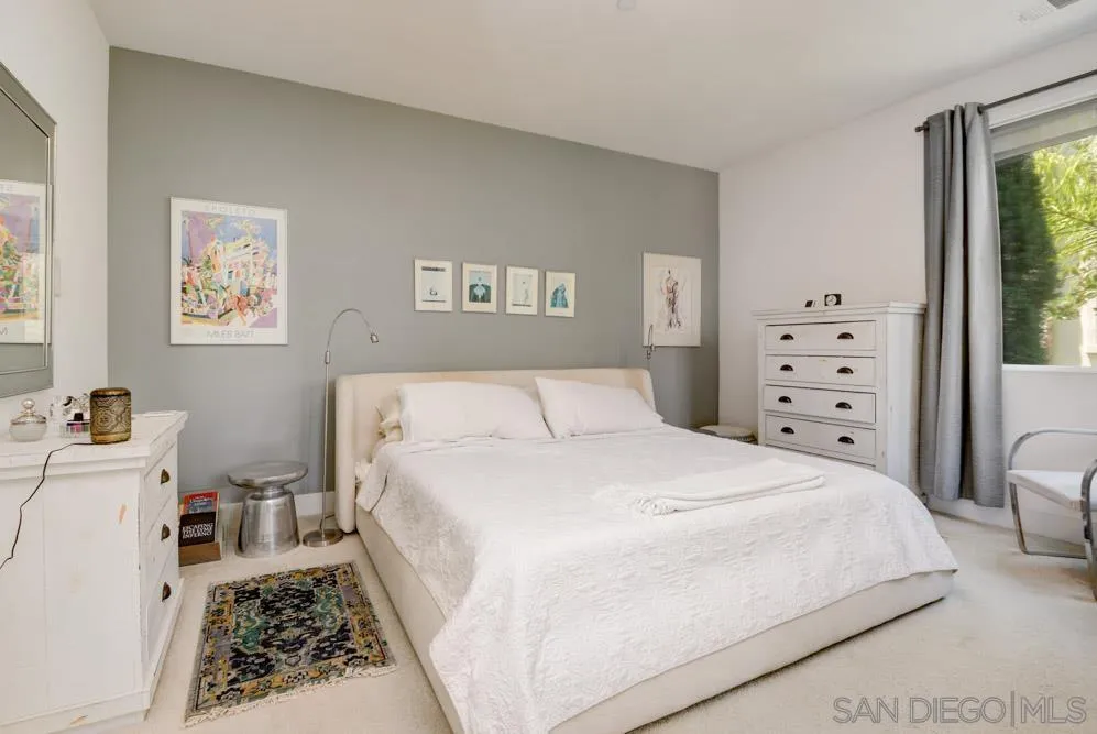 7832 Inception Way San Diego, CA 92108 - Photo 13 of 31 a large bed sitting in a bedroom and a baby crib