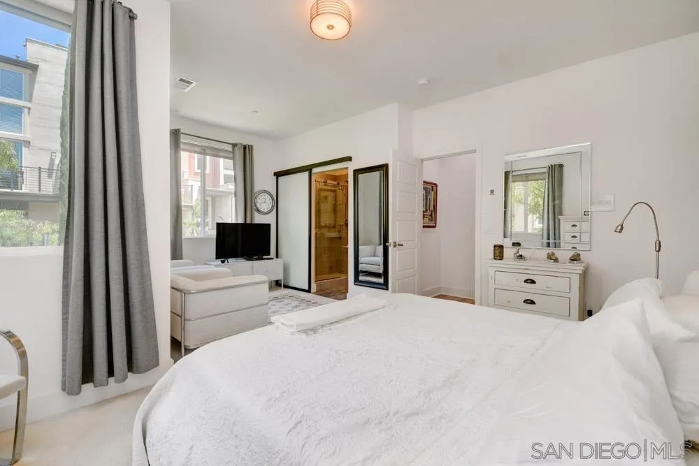 7832 Inception Way San Diego, CA 92108 - Photo 14 of 31 a bedroom with a large bed and a large window