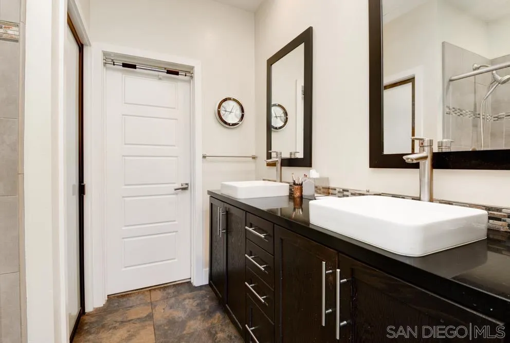 7832 Inception Way San Diego, CA 92108 - Photo 15 of 31 a bathroom with a double vanity sink and a mirror
