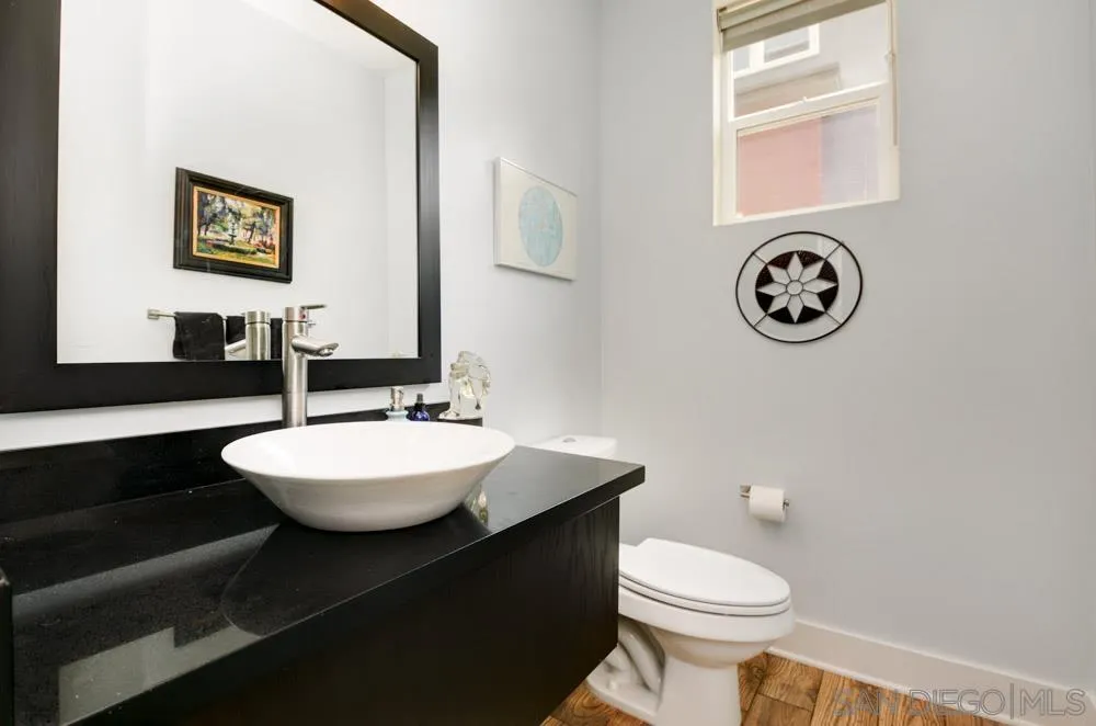 7832 Inception Way San Diego, CA 92108 - Photo 18 of 31 a bathroom with a toilet a sink and a mirror