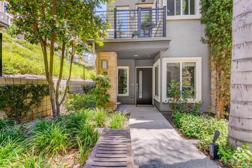 7832 Inception Way San Diego, CA 92108 - Photo 20 of 31 a front view of a house with a yard and potted plants