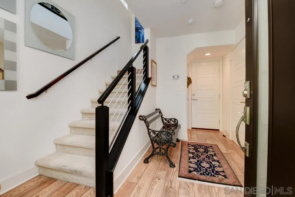 7832 Inception Way San Diego, CA 92108 - Photo 2 of 31 a view of entryway with wooden floor and a rug