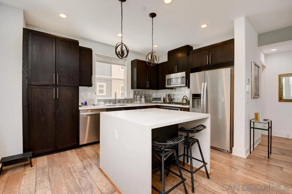7832 Inception Way San Diego, CA 92108 - Photo 7 of 31 a kitchen with stainless steel appliances a refrigerator and a stove top oven