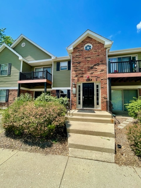 1352 McDowell Road, Unit 101 Naperville, IL 60563 - Photo 1 of 19 a front view of a house with a yard