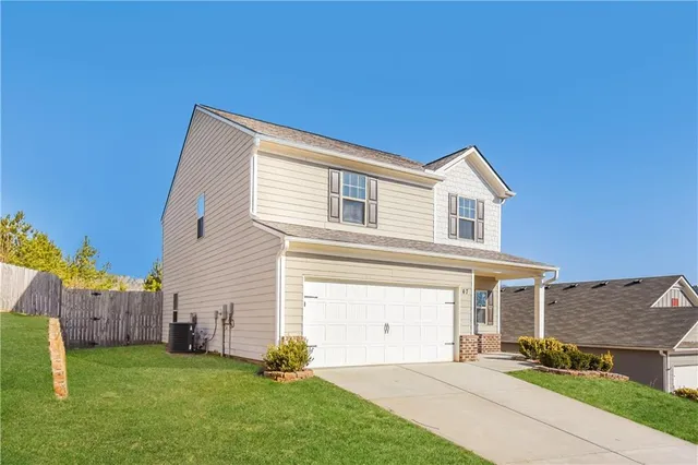 a front view of a house with a yard and garage