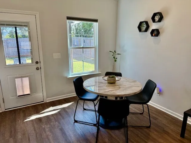 a view of a workspace with furniture and window
