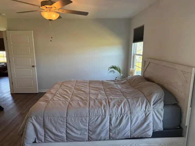 a bedroom with a bed and a chandelier