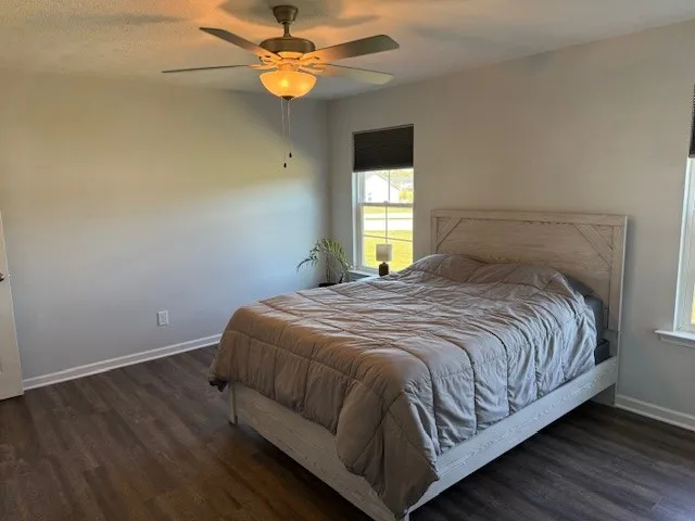 a bedroom with a bed and window