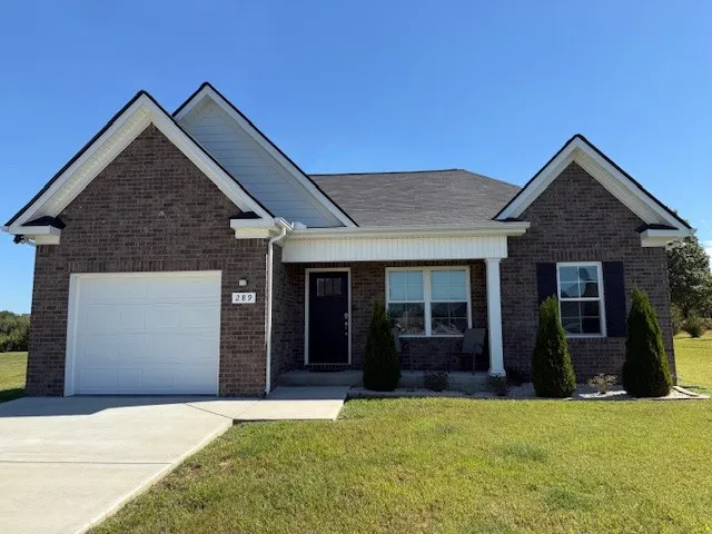 a front view of a house with a yard