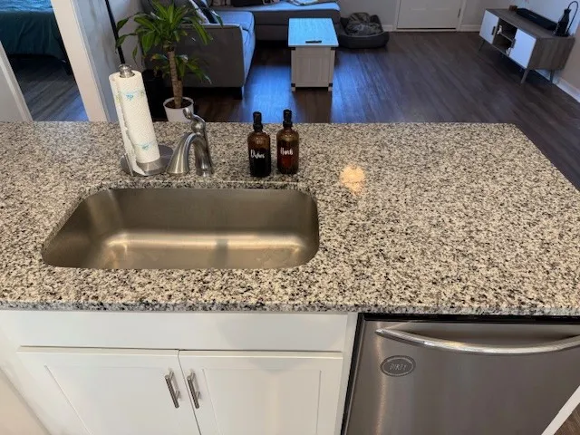 a kitchen with a table chairs and wooden floor