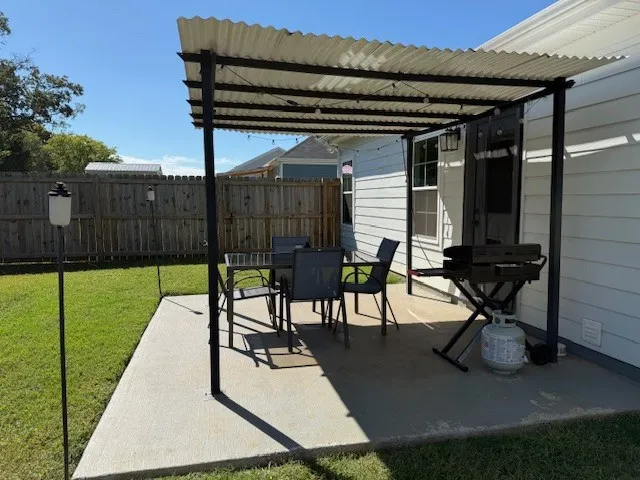 a view of a porch with furniture and floor to ceiling window
