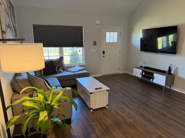 a living room with furniture and a flat screen tv