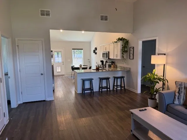 a living room with furniture and wooden floor