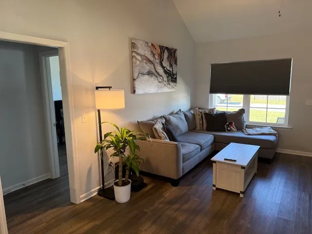 a living room with furniture and wooden floor