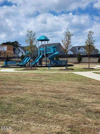 a view of a swimming pool with an outdoor seating and a yard