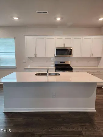 a kitchen with a cabinets and a microwave