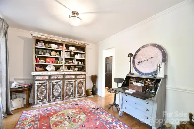 a living room with hard wood furniture and a wooden floor