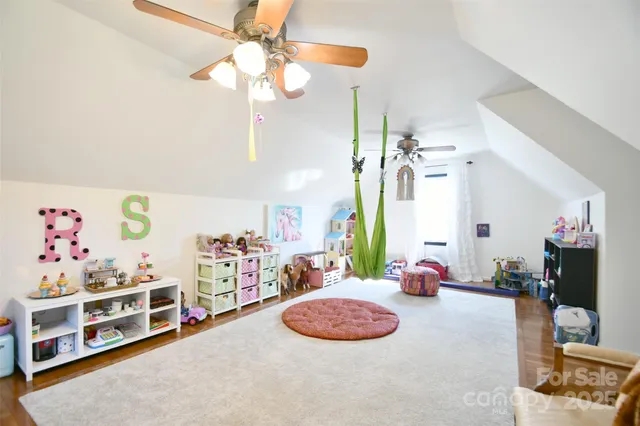 a bedroom with furniture a chandelier and a window