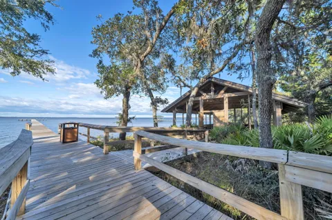 a front view of a building with many trees