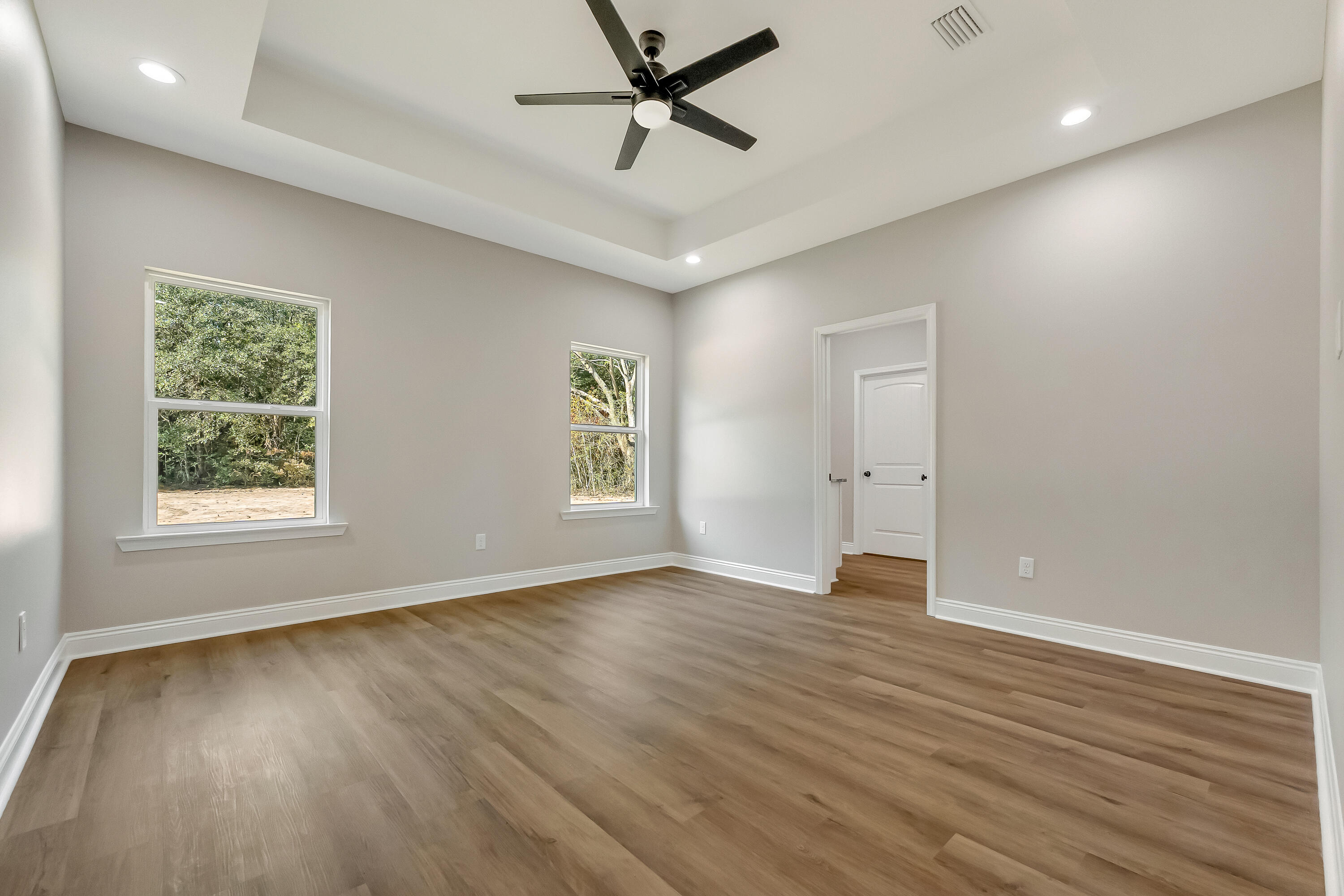 2.93-ac Goodwin Road Crestview, FL 32539 - Photo 22 of 45 an empty room with wooden floor and windows
