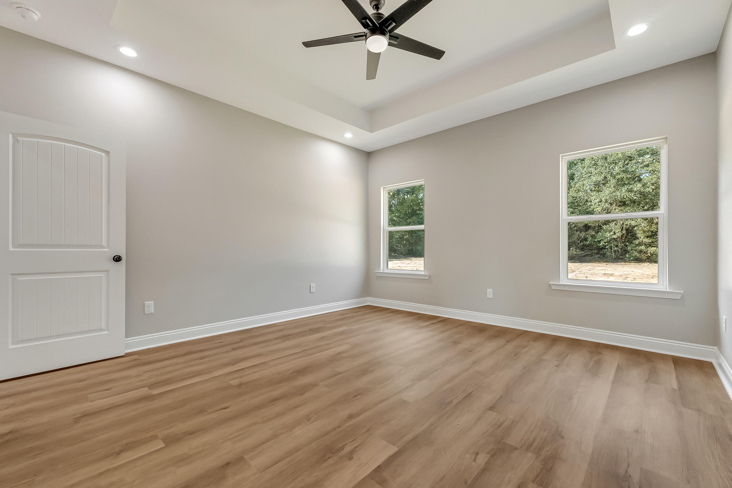 2.93-ac Goodwin Road Crestview, FL 32539 - Photo 25 of 45 an empty room with wooden floor chandelier fan and windows