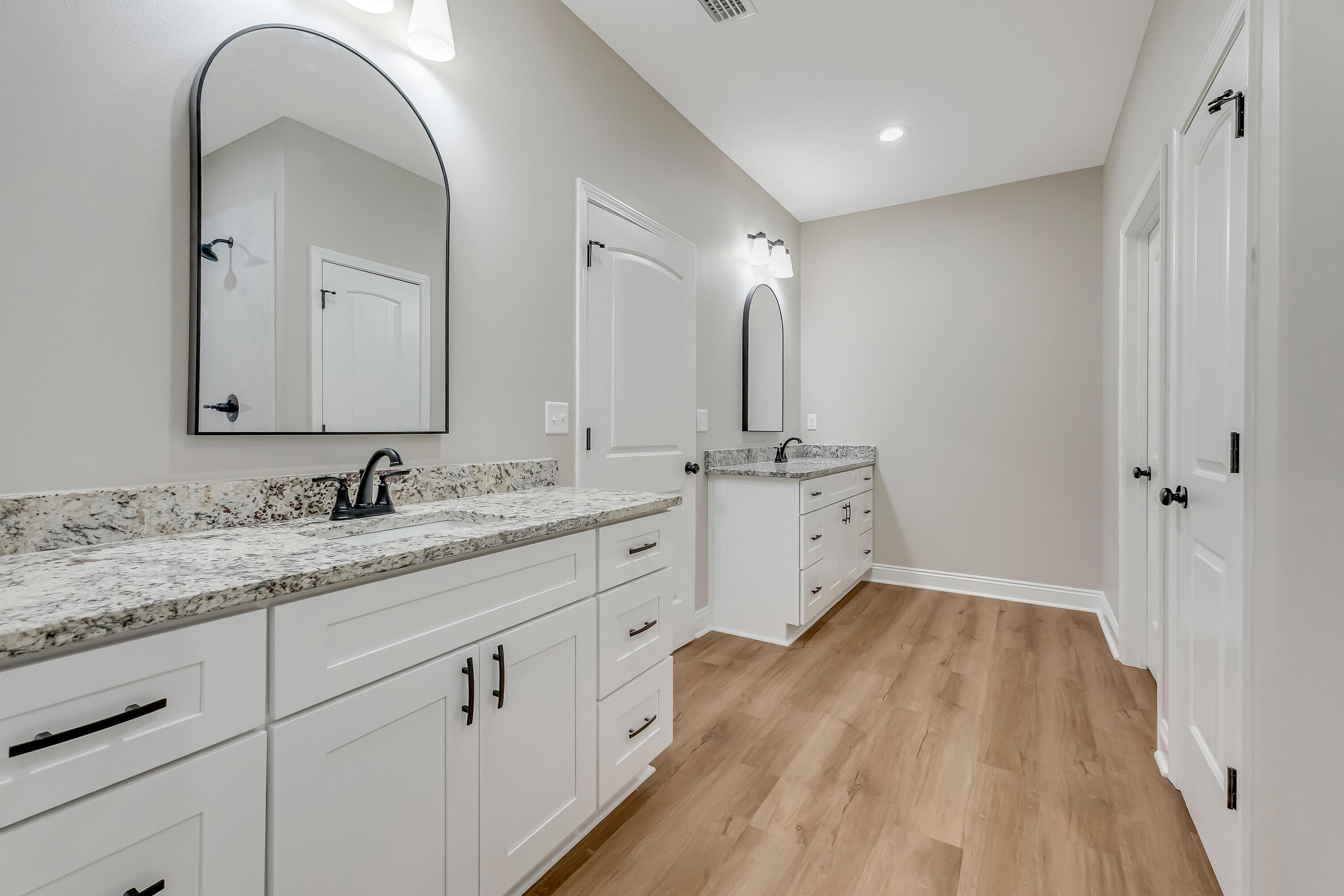 2.93-ac Goodwin Road Crestview, FL 32539 - Photo 26 of 45 a spacious bathroom with a double vanity sink and mirror