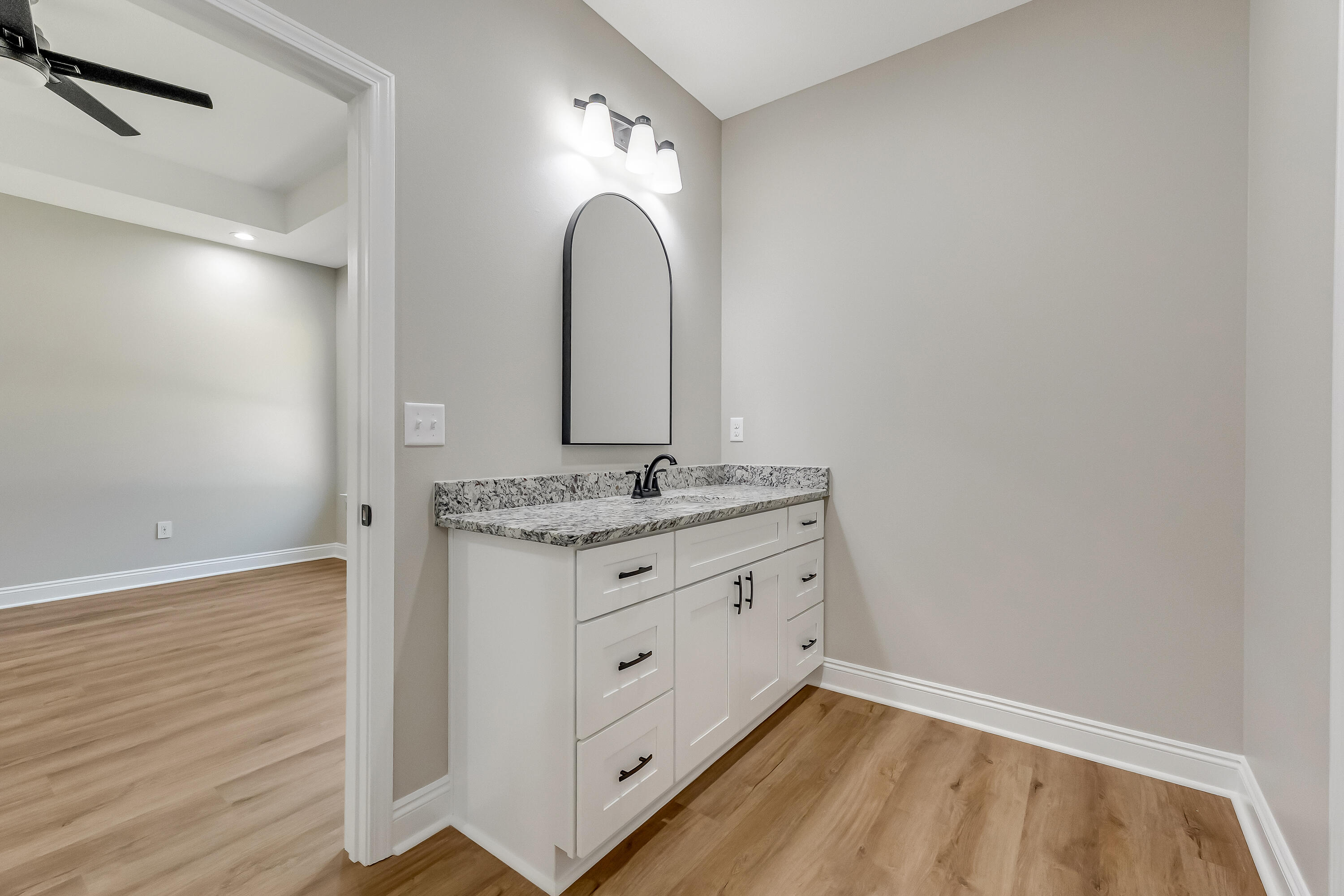 2.93-ac Goodwin Road Crestview, FL 32539 - Photo 28 of 45 a bathroom with a granite countertop sink and a mirror