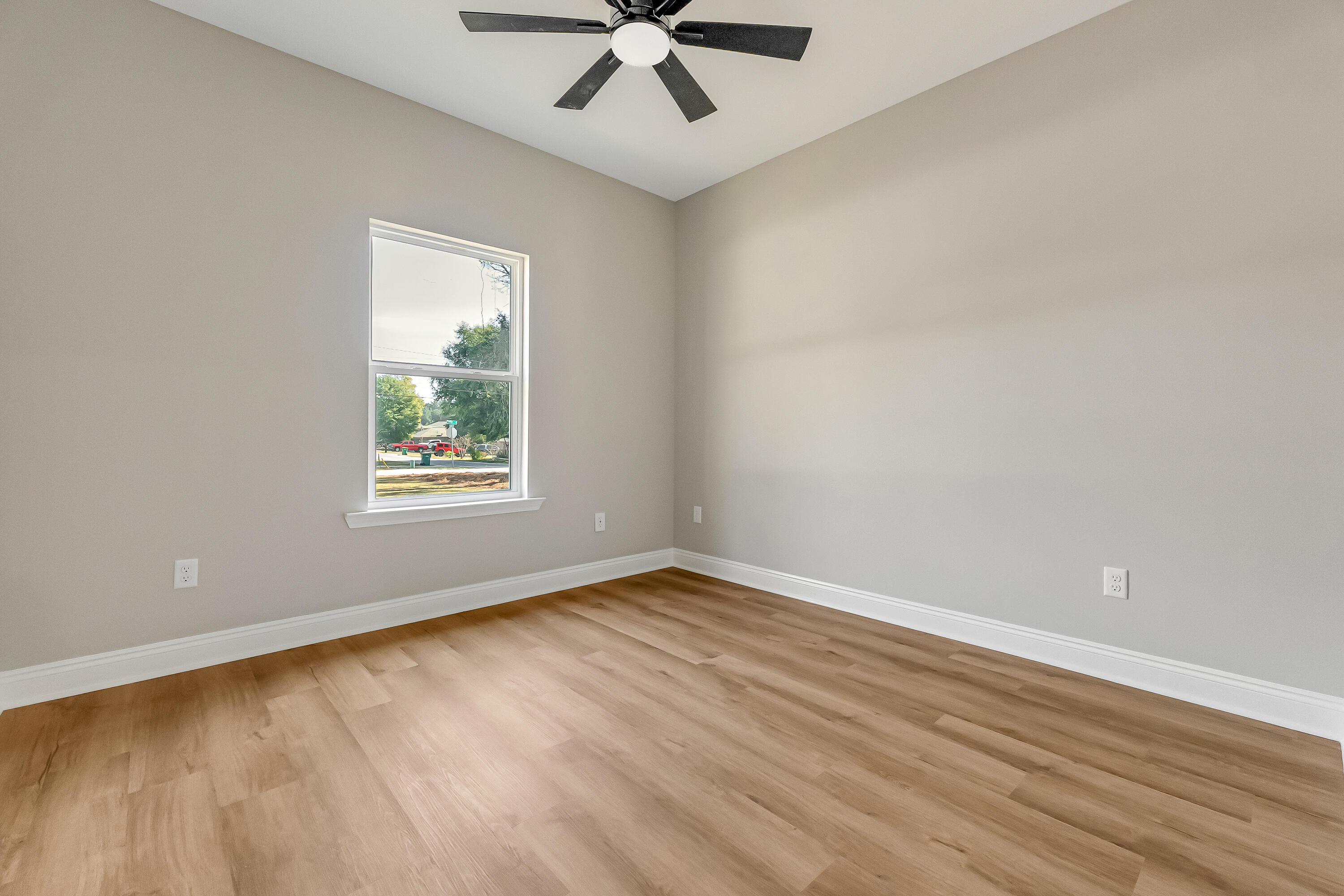 2.93-ac Goodwin Road Crestview, FL 32539 - Photo 34 of 45 an empty room with wooden floor chandelier fan and windows