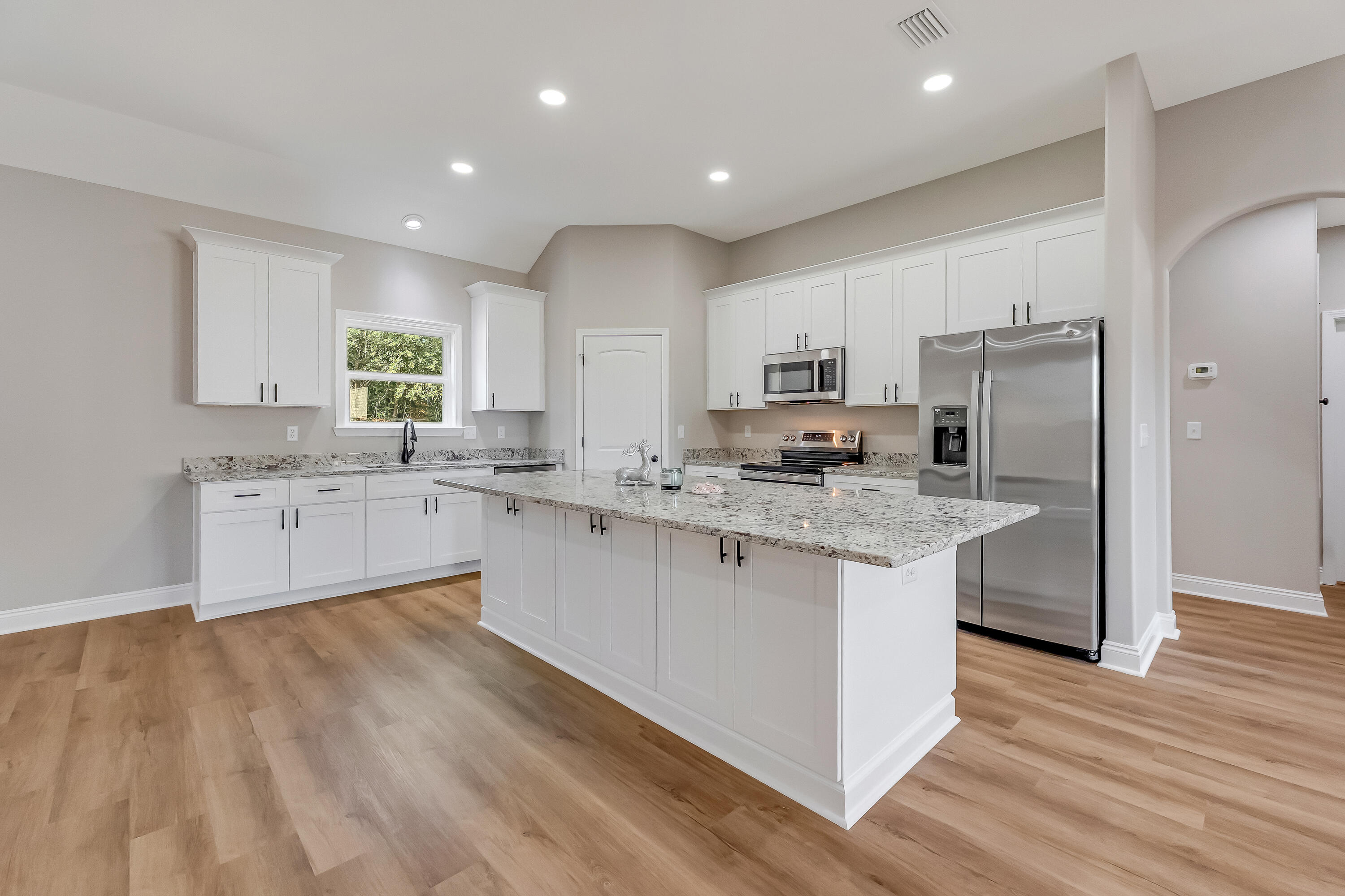 2.93-ac Goodwin Road Crestview, FL 32539 - Photo 5 of 45 a kitchen with kitchen island granite countertop a sink cabinets and stainless steel appliances