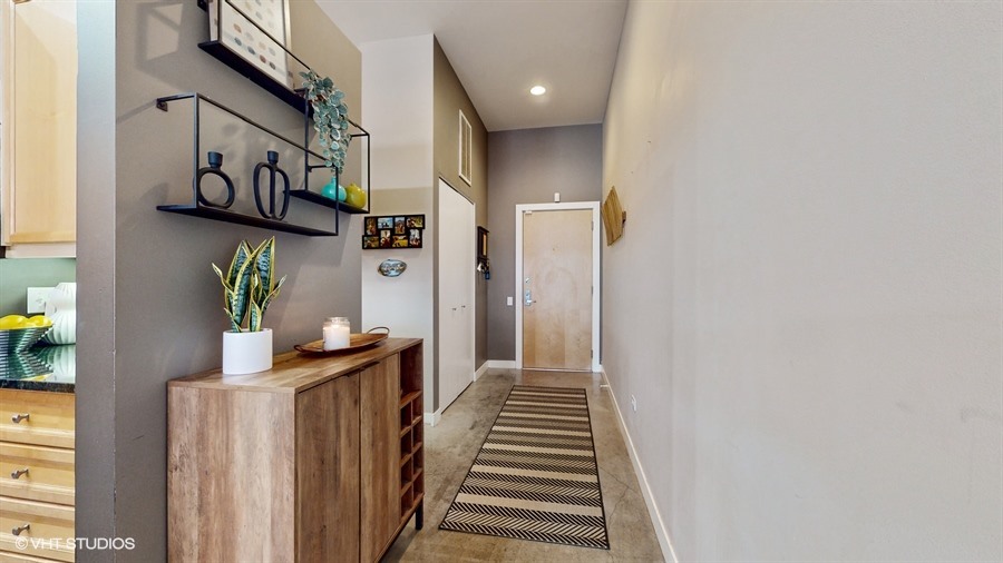 949 West Madison Street, Unit 401 Chicago, IL 60607 - Photo 2 of 14 a view of a hallway with paintings on the wall