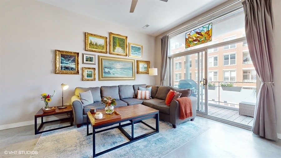 949 West Madison Street, Unit 401 Chicago, IL 60607 - Photo 3 of 14 a living room with furniture and a floor to ceiling window