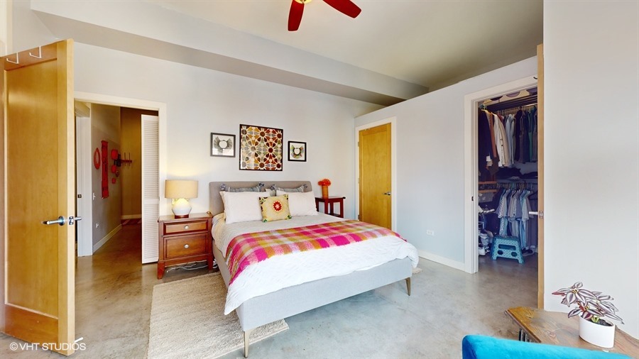949 West Madison Street, Unit 401 Chicago, IL 60607 - Photo 7 of 14 a bedroom with a bed and a couch